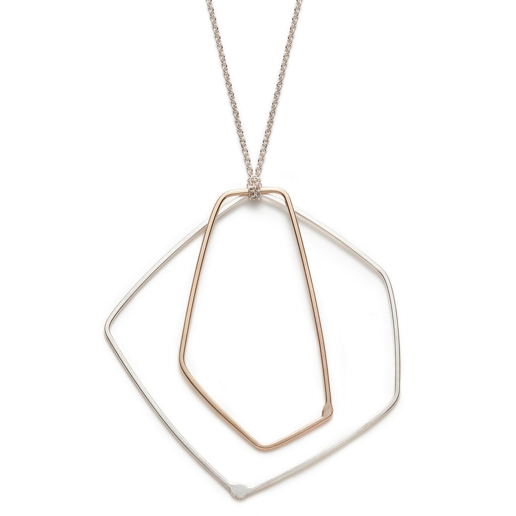 Sterling silver and 10k gold necklace with a silver chain designed by Gabrielle Desmarais.