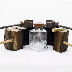 A mold-blown glass decanter with wooden cork and the wooden mold used to create it. 