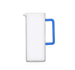 Decorative tube water jug made of glass with a blue handle.