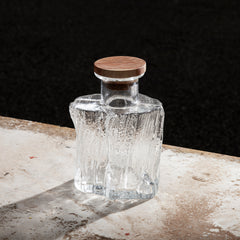 A glass decanter with wooden cork. 